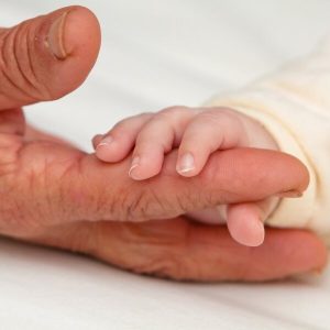 Grandparent and baby holding fingers protect your legacy reputation my info tech partner it services perth it support perth cyber security perth